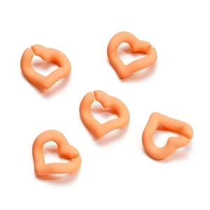 Close-up of matte orange heart-shaped acrylic rings for DIY jewelry and accessory making