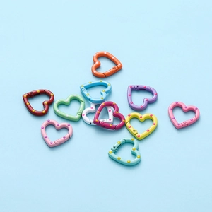 Close-up of colorful heart-shaped spring buckles with polka dot pattern for DIY crafts