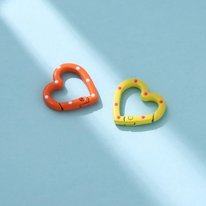 Close-up of heart-shaped colorful polka dot metal spring buckles for DIY accessories