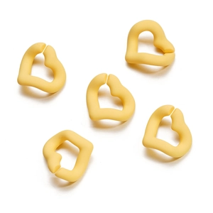 Detail of 5 matte yellow irregular heart-shaped acrylic rings for DIY jewelry projects