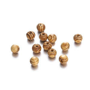 Detail of round maple wood beads with dark grain stripes and pre-drilled holes for DIY