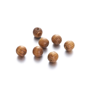 Macro detail of natural maple wood beads showing wood grain textures and central holes
