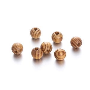 Macro detail of natural maple wood beads with unique wood grain for DIY jewelry