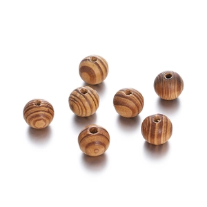 Macro detail of natural maple wood beads with grain texture and pre-drilled holes for DIY