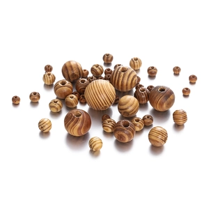 Macro view of natural maple wood beads with brown stripes and central drill holes
