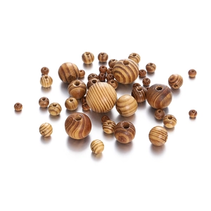Macro shot of maple wood beads with zebra grain and drilled holes for jewelry making