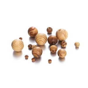 Macro detail of natural maple wood beads showing wood grain texture and center drill holes