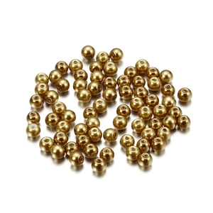 Close-up of 4mm golden faux pearl beads with smooth finish for DIY jewelry making