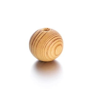 Macro detail of natural maple wood bead with visible grain pattern and drilled hole