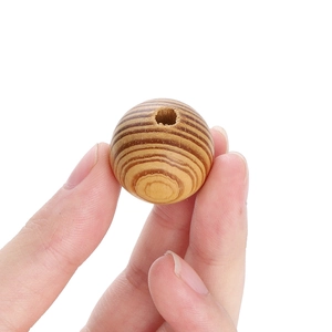 Natural maple wood round beads with visible grain and pre-drilled holes for DIY jewelry