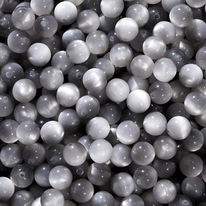 Macro detail of silver gray resin cat eye beads for jewelry making and DIY beadwork