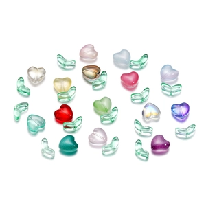 Dettaglio di perline di vetro colorate a cuore e foglie per creazione gioielli fai-da-te