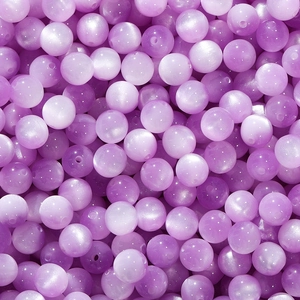 Macro detail of light purple resin cat-eye beads with smooth finish for DIY jewelry making