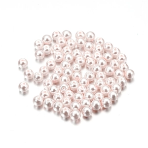 Macro shot of 4mm pale pink glass imitation pearls with smooth finish and pre-drilled holes