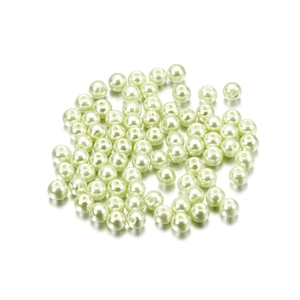 Macro shot of 4mm cream faux pearl glass beads with central hole for DIY jewelry making