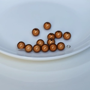 Detail of vintage bronze round beads with metallic luster for DIY jewelry making