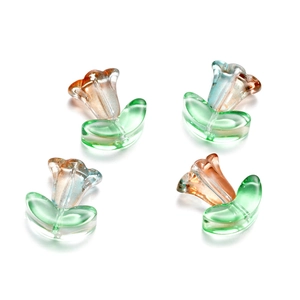 Detail of four glass tulip flower beads with green leaf base for DIY jewelry making