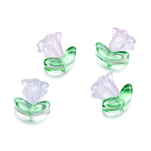 Detailed view of four purple tulip glass beads with green leaves for DIY jewelry making