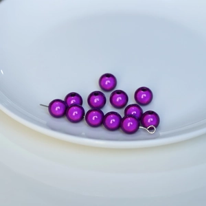 Macro shot of purple metallic resin beads for DIY jewelry with iridescent finish