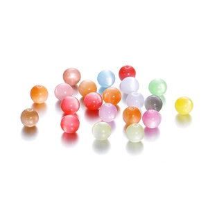 Close-up of assorted resin cat eye beads in vibrant colors for jewelry making DIY