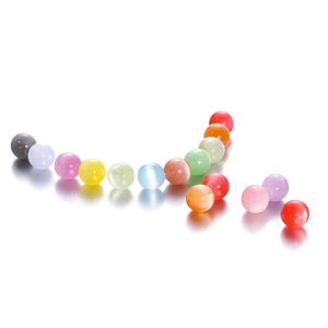 Macro shot of colorful resin cat-eye beads with holes for DIY jewelry making and crafts