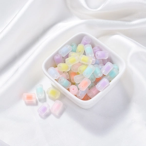 Close-up of matte acrylic cylindrical beads with colorful candy cores for DIY jewelry