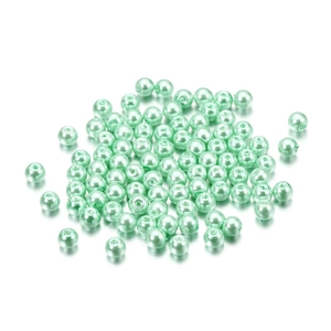 Macro shot of 4mm mint green glass faux pearl beads with hole for DIY jewelry making