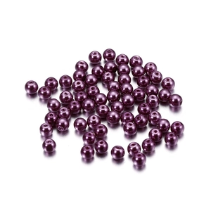 Macro detail of 4mm dark purple glass faux pearl beads with hole for DIY jewelry making