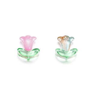 Macro detail of tulip glass beads with green leaves for DIY jewelry making