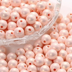 Detailed view of light pink macaron pearl acrylic beads with glossy finish for DIY jewelry