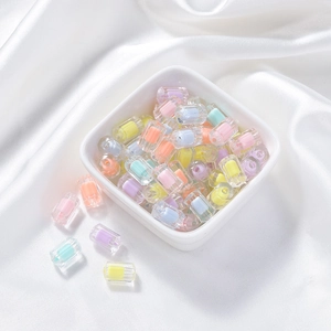 Macro view of colorful frosted acrylic double-layer beads in a white ceramic bowl