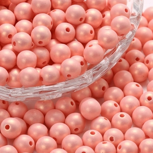 Macro shot of pink macaron pearl acrylic beads with a soft matte finish for DIY jewelry making