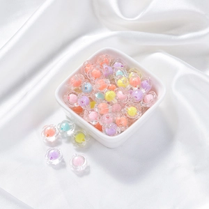 Macro shot of colorful acrylic flower beads for DIY jewelry making on white silk