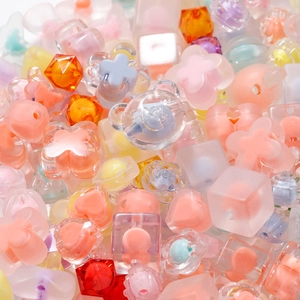 Macro shot of assorted colorful acrylic beads in bear, flower and heart shapes for DIY