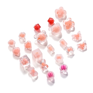 Detail of pink acrylic frosted beads in bear and flower shapes for DIY jewelry making