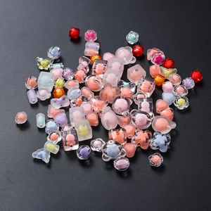 Detailed macro view of mixed acrylic colorful beads in bear, heart, and flower shapes
