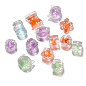 Close-up of frosted acrylic beads in candy and animal shapes for DIY jewelry making