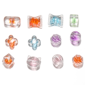 Macro view of assorted frosted acrylic beads in heart, flower and animal shapes for DIY