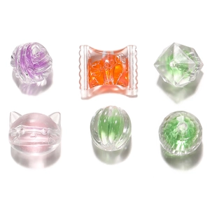 Macro shot of colorful acrylic candy and animal shaped beads with internal cores for DIY crafts