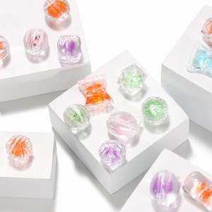 Close-up of frosted acrylic beads in various shapes for DIY jewelry making accessories