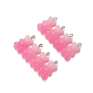 Detail of pink gradient resin gummy bear charms with glitter and silver metal loops