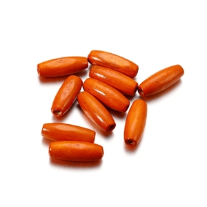 Close-up of bright orange oval maple wood beads with 2.5mm hole for DIY jewelry making