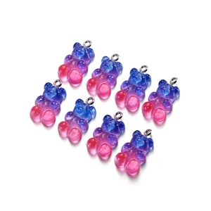 Macro detail of gradient resin bear pendants with glitter and silver metal eyelets