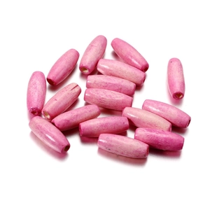 Close-up of bright pink oval maple wood beads with natural grain for DIY jewelry making