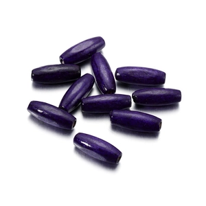 Macro detail of dark purple oval maple wood beads with 2.5mm hole for DIY crafting