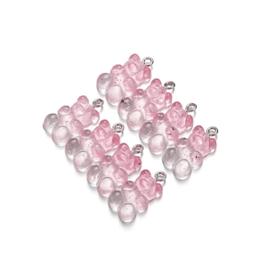 Detail of pink transparent resin bear charms with silver jump rings for DIY jewelry making