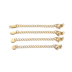 Detailed view of four golden stainless steel extension chains with S.steel engraved tags