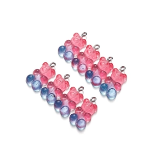 Close-up of translucent gradient resin bears with silver loops for DIY jewelry making