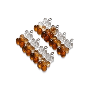 Macro shot of 8 gradient amber resin teddy bear pendants with silver metal rings