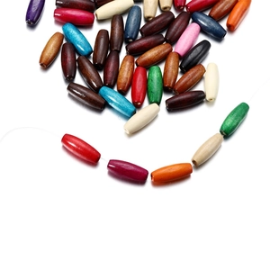 Detailed macro view of mixed colorful oval wooden beads for DIY handicraft and jewelry
